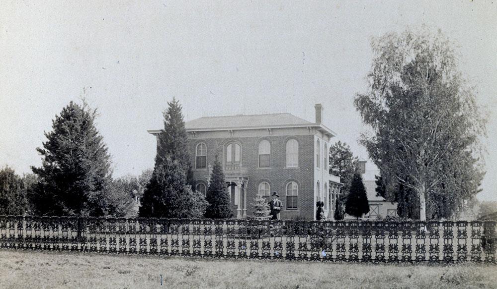 A photograph of the Gaunt family home, circa 1889, with the lawn's original cast-iron fence.